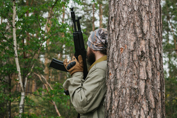 Naklejka premium Armed man in a zone of armed conflict