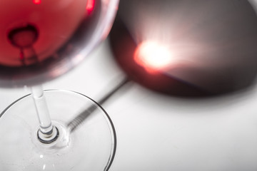 Wineglass with red wine on a white silhouette background