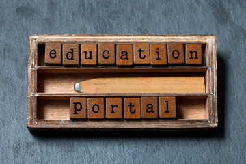 Education portal conceptual image. Vintage blocks with text, retro style pencil in wooden box. Gray...