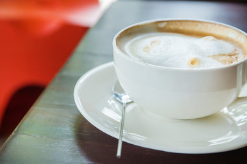 coffee with spice and artistic foam in a white cup