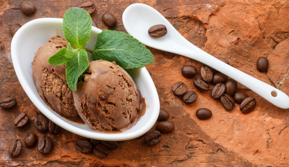 Coffee ice cream with mint leaves in a white Cup