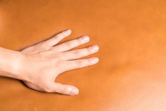 Hand on leather background