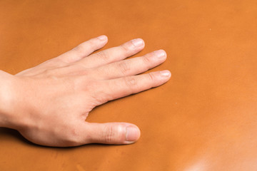 Hand on leather background