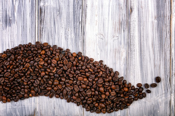 Coffee beans stacked  on the old wooden background