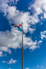 Luxembourg flag with sky and white clouds