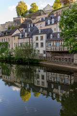 Fototapeta na wymiar Colorful buildings reflecting in the Alzette river in the city o