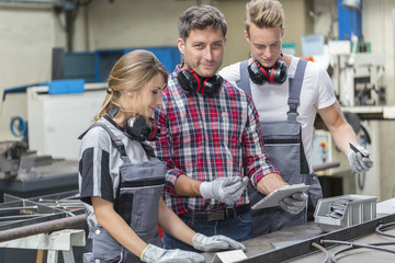 young apprentice with professional metallurgist