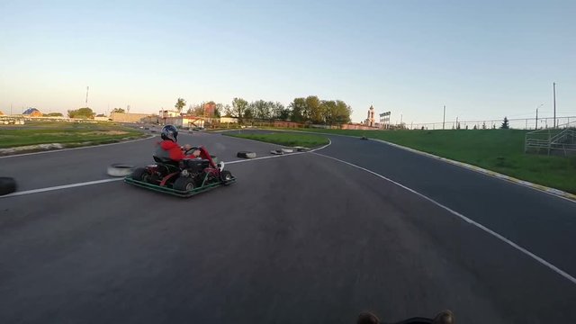 man drives go kart on track unroll