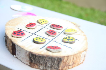 Painted stounes with dots for gaming. Colorful stoune set on wood background.