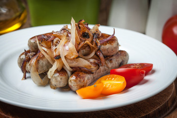 Fried Fried white sausages with onion on the plate.white sausage