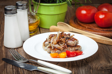 Fried Fried white sausages with onion on the plate.white sausage