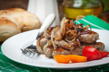 Fried Fried white sausages with onion on the plate.white sausage