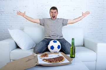 man celebrating goal at home couch watching football game on television