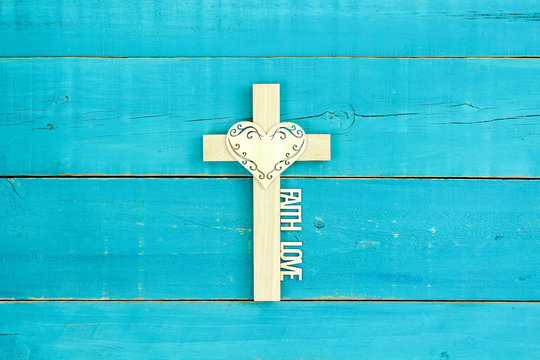 Wood cross with lace heart, FAITH and LOVE on antique rustic teal blue wood background
