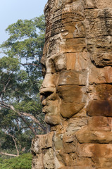 Stone face in Bayon Temple at Angkor Wat complex in Siem Reap Cambodia