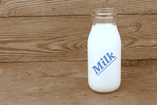Milk and old style bottle on wood table