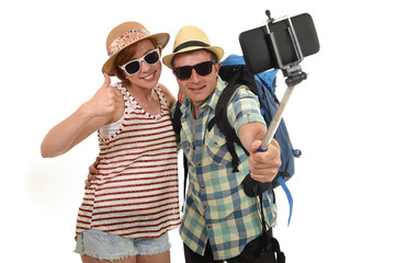 young attractive and chic American couple taking selfie photo with mobile phone isolated on white