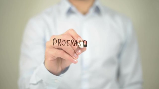 Procrastination , Man writing on transparent screen
