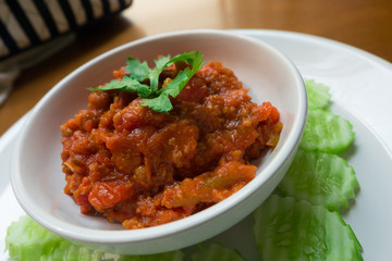 Thai Northern local Style minced Pork and Tomato Relish paste dip. Nam Prik Ong. 
very famous spicy yummy hot chilli pepper paste sauce.
together with vegetable like cucumber. 