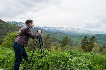 Nature photographer taking photos in the mountains