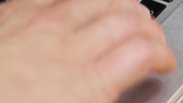 Hand repeatedly pressing the enter key on a macbook laptop keyboard, close up shot, seamless looping, perfect for describing a nervous computer user
