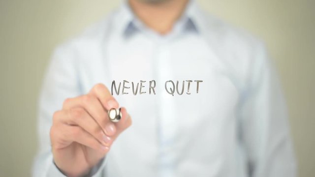 Never Quit on Yourself , Man writing on transparent screen