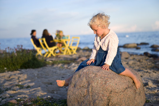 A girl sitting on a rock, Oland, Sweden.