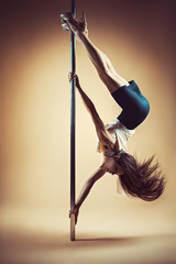 Young woman pole dancing