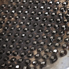 Metal surface covered with holes