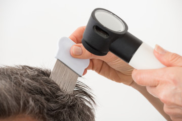 Doctor Examining Patient's Hair