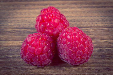 Vintage photo, Fresh raspberries on wooden surface, healthy food