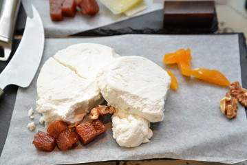 Manchego cheese with knife and dried fruit and walnut