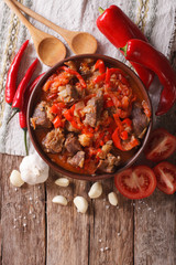 Oriental cuisine: lamb slow stewed with vegetables closeup. vertical top view
