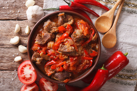 lamb slow stewed with onion, tomato and pepper closeup. horizontal top view
