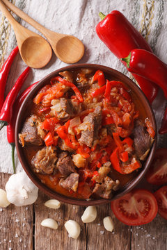 lamb slow stewed with onion, tomato and pepper closeup. vertical top view
