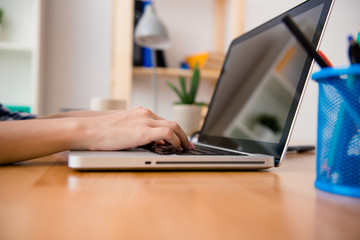 Close up photo of man writting new book on laptop