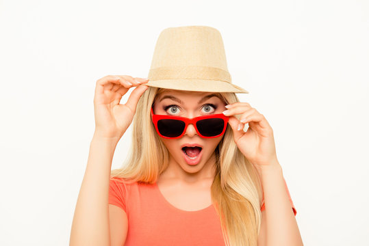 Surprised  young woman in hat and glasses with open mouth