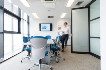 business people group entering meeting room, motion blur