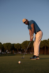golfer  hitting shot at golf course