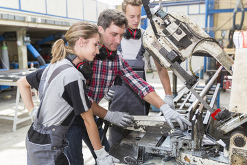 young apprentice with professional metallurgist