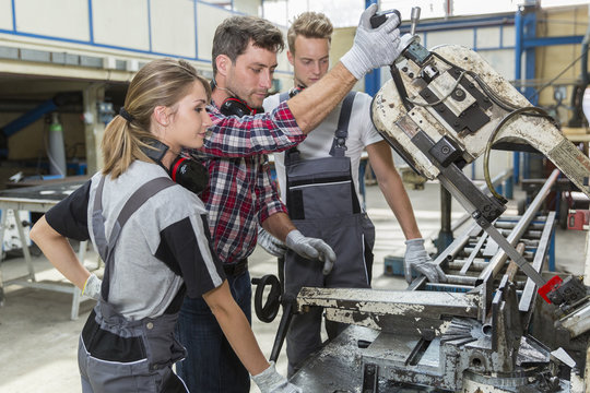 young apprentice with professional metallurgist