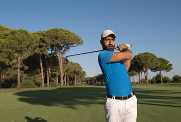 golf player hitting shot