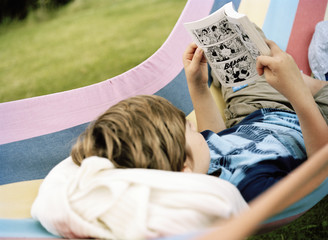 A boy reading a comic.