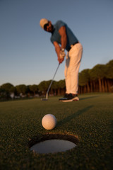 golfer  hitting shot at golf course