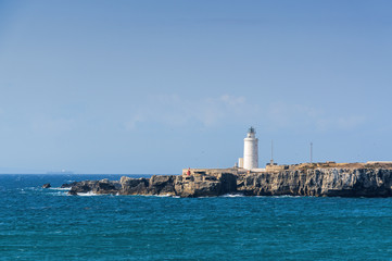Fototapeta na wymiar Sunny view of lighthouse of Tarifa port, Andalusia provice, Spain.