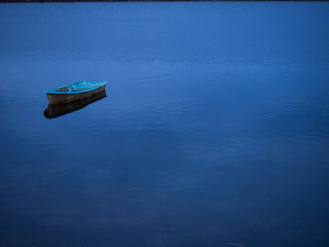 lonely boat lake with bluesky