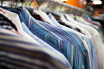 Collection of male shirts on rack