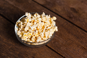 Salt popcorn on the wooden table
