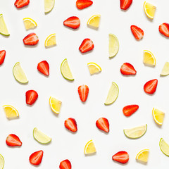 Colorful pattern of strawberries, lime, lemon. Top view of the citrus fruits and sliced...