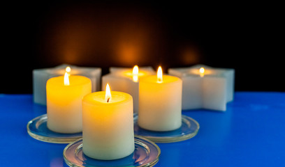 closeup to burning candles in darkness